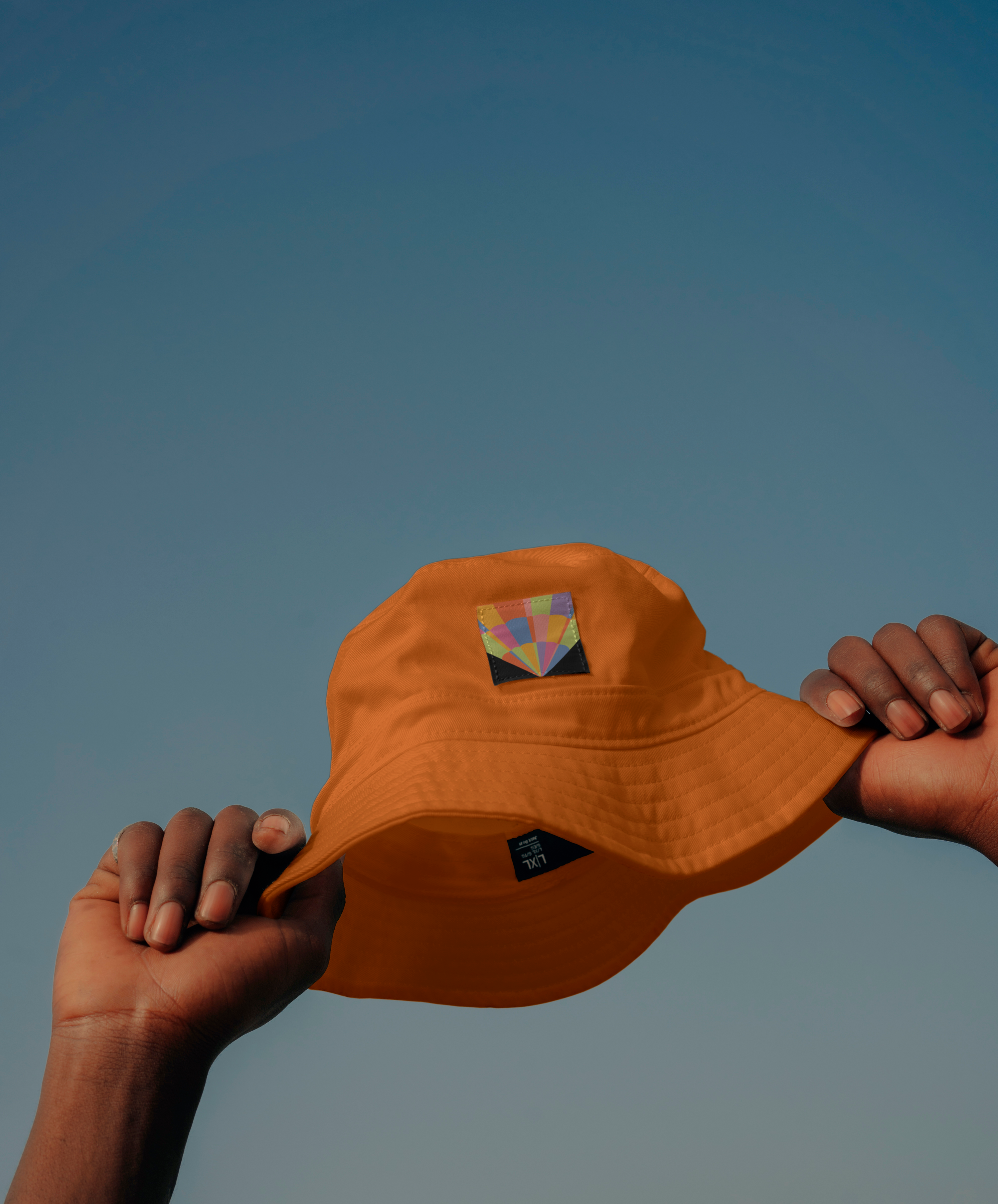 Balloon Fiesta identity applied to an orange hat